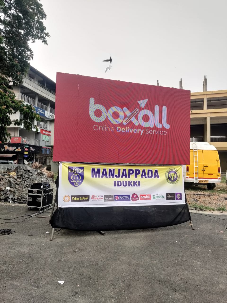 A large Boxall screen above a Kerala Blasters Manjappada Idukki banner at a supporters' event, with Boxall among the sponsors listed below